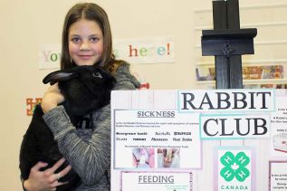 Delana Raney holds Oliver, a Flemish rabbit, at the Frontenac 4H open house last Friday night. Photo/Craig Bakay